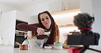 Live streaming, woman and food for a blog in the kitchen for a cooking tutorial on the internet. House, baker or a female influencer or chef speaking about ingredients for a broadcast or online video