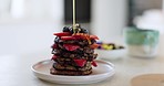 Pancake stack, honey and fruit with breakfast and food in kitchen with creativity and nutrition. Bakery, cafe with syrup drizzle and cooking with blueberry and strawberry, meal with art and catering