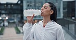 City. fitness and woman drinking water, exercise and health with nutrition, hydration and training. Person, athlete or girl with a bottle, thirsty or aqua with wellness, workout or runner with energy