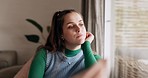 Thinking, depression and young woman in the living room to relax on a weekend with mental health. Sad, dreaming and female person from Australia sitting on chair by window in the lounge of apartment.