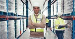 Industry, crossed arms and man in a busy warehouse for inventory, stock check or distribution. Engineering, confidence and portrait of serious Mexican male industrial worker at a logistics factory.