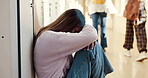 Sad, depression and student on floor in college hallway with anxiety and burnout from school work or loan debt. Stress, university and upset girl cry on ground for mental health crisis and bullying