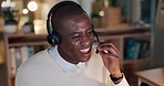 Business man, call center and speaking, night communication or technical support for software solution. Happy african person, agent or consultant laughing at IT agency, helping and advice on computer