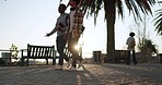 People, walk and outdoor with morning sunrise commute and travel on a plaza and sidewalk. Traveling, step and students on concrete going to university, college and school class on foot path on campus