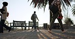 People, walking and outdoor with morning commute and travel on a plaza and sidewalk. Traveling, step and students on concrete going to university, college and school class on a foot path on campus