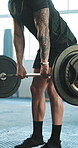 Weightlifting, fitness and a strong man at the gym for training, bodybuilding or exercise. Serious, sports and an athlete or bodybuilder with strength and club equipment for wellness or a workout