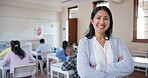 Smile, arms crossed and a woman teacher in her classroom for education, learning or development. Portrait, school and confident with a happy professor in a class for teaching, training or scholarship