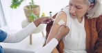 Old woman, medical and nurse with a plaster, arm vaccine and healthcare treatment with cure for disease. Senior person, pensioner and doctor with elderly lady, injection bandage, patient and safety