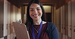 Education, teacher and clipboard with smile in school corridor for learning, knowledge and happiness inside. College, working and portrait of woman on campus at university for lecture and teaching 
