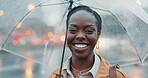 Black woman, travel and city with umbrella and face, insurance and rain with smile outdoor. Commute, journey to work and wet winter weather, urban street and professional in portrait with security