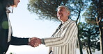 Partnership, women or business people shaking hands in park b2b meeting or project agreement. Teamwork, handshake greeting or mature person with job promotion, deal negotiation or hiring opportunity