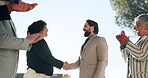 Collaboration, handshake and applause with a business team in celebration of a goal or target together outdoor. Teamwork, motivation and support of achievement with an employee group shaking hands