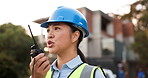 Asian woman, architect and walkie talkie in construction planning, conversation or communication on site. Female person, engineer or contractor talking on radio for architecture plan or discussion