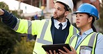 Tablet, man and woman at construction site for inspection at urban building for development, quality control and safety. Engineering team, ideas and project management checklist for planning online.