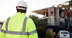 Man, construction worker and maintenance with engineering and contractor, helmet and reflector jacket with back view. Infrastructure, building site and labor with architecture and handyman outdoor