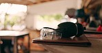 Goggles, table and carpentry tools in closeup, construction and notebook in workshop for industry. Glasses, warehouse or garage with headphones, maintenance and hardware for creativity in workplace