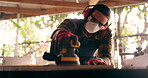 Construction, carpenter and handyman with wood project in workshop at home for renovation and maintenance. Contractor, machine an person with ppe and bokeh in workplace at house for for carpentry