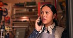 Asian woman, phone call and carpenter in conversation, advice or consulting in room of tools or workshop. Female person or woodworker talking on mobile smartphone to customer or client in discussion