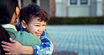 Mother, happy child and hug at school outdoor for care, love and bonding together. Mom, kid smile and running to embrace student for support, trust and welcome greeting after learning and education