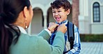 First day of school, mother and child getting ready for kindergarten, support and care. Mom, student and help with clothes to prepare button for kid to start learning, education and excited to study