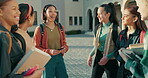 University, campus and group of students talking in conversation on a break together for learning or education. College, youth and friends in discussion of exam results, books or scholarship