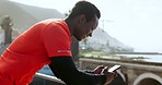 Outdoor, fitness and black man with a smartphone, smile and typing with connection, meme and wellness. Relax, African person and athlete with a cellphone, mobile app and social media with exercise