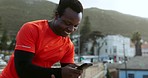 Runner black man, phone and texting outdoor with smile, reading and laugh for comic meme on urban rooftop. Guy, smartphone and happy for contact, video and social media with training in metro cbd