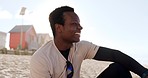 Travel, happy and black man at a beach thinking, relax and enjoy freedom in nature with positive mindset. Ocean, holiday and African male smile at the sea for tropical, vacation and weekend sea trip