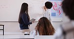 School, education and teacher writing on board for lesson, learning and answer to questions in classroom. College, biology and educator with students for knowledge, solution and explain coursework
