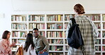 People, students walking or man in library for education, knowledge or study group for college project. Learning, fist bump or start of conversation with studying talk or teamwork in school meeting