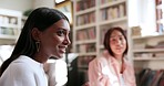 Library, study group and woman talking in university, education and knowledge together. College, students and happy people in conversation, friends learning and communication in teamwork to research