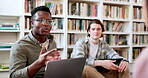 Library, study group and student man with conversation and book planning for college project. Books, talking and communication for learning and studying for exam with friends or class in university