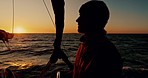 Sailing, man and sunset on a boat and yacht outdoor with water travel on a calm ocean and sea. Wind, vacation sun and journey in summer with journey for holiday and relax male sailor thinking