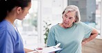 Consulting, healthcare or back pain with a nurse and patient in a hospital to answer questions at a checkup. Medical, insurance or checklist with a medicine professional and senior person in a clinic