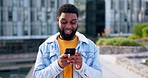 Black man, smartphone and communication in the city, chat and social media with funny meme and network. Contact, internet and online, reading email with technology and using phone outdoor for app