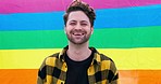 Pride, flag and gay, happy man and LGBTQ community with smile in portrait, support and freedom to love. Inclusion, equality and rainbow with human rights, happiness and symbol for queer sexuality