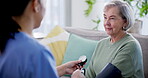 Blood pressure, test and nurse help senior woman on retirement with consultation on couch in home for support. Care, medical and caregiver with advice for elderly person in healthcare exam on sofa