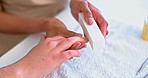 Hands of woman at spa, filing and shape with technician for beauty, luxury grooming and cosmetics. Professional manicure service, self care and girl at salon for aesthetic, wellness and shine on nail