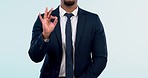 Business, closeup and man with ok hand, agreement and support on a white studio background. Person, employee or consultant in a suit, sign or symbol for perfect, like or emoji with review or feedback