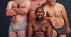 Beauty, diversity and self confidence with men in underwear in studio for skincare, health and body positivity. Support, wellness and pride with portrait of group of people on dark background