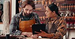 Leather workshop, man and woman with tablet, discussion and tools for manufacturing of unique textile product. Ecommerce, online sales and team at small business tannery planning schedule together.