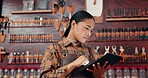 Leather factory, woman in with tablet and tools for manufacturing of unique textile product. Digital app, small business owner and girl at workshop with online research,  thinking at repair service.