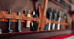 Workshop, tools and repair shop wall with equipment on shelf at a workplace for maintenance and creativity. Set of metal objects on a leather belt for art, engineering or art and craft manufacturing