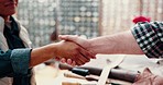 Greeting, service and people at a workshop with a handshake for trust, thank you or a deal. Leather shop, meeting and a customer shaking hands with a person for repairs and maintenance agreement