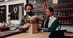 Packing, leather and people closing a box at a shop for export, manufacturing or service together. Small business, retail and man, woman or employees with cargo from production for a gift or shipping