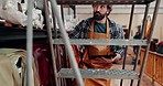 Tablet, leather workshop and man on steps at shelf for fabric choice in small business. Tech, craftsman and person select tannery textile in factory for production, manufacturing and work on ladder