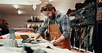 Laptop, writing and online order with a man in a leather workshop for design in the textile industry. Computer, email and creative with an artisan in a studio for production or handmade craftsmanship