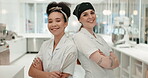 Team, chef and women smile with arms crossed in kitchen at restaurant for hotel service. Portrait, cooking and collaboration with culinary professional and employee for catering career or competition