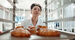 Pastry chef, restaurant and woman in commercial kitchen for baking job. Professional baker person walking with food trolley for catering or bakery industry production, breakfast croissant or service