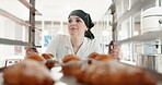 Restaurant, pastry chef and woman in commercial kitchen for baking job. Professional baker person walking with food trolley for catering or bakery industry production, breakfast croissant or service